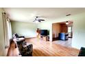 Spacious living room boasts hardwood floors, ample natural light, and a ceiling fan for added comfort at 16905 Sw 30Th Avenue Rd, Ocala, FL 34473
