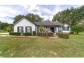 Charming single-story home featuring tidy landscaping and a covered porch at 10600 Se 32Nd Ave, Ocala, FL 34480