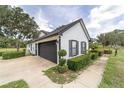 Side view showing the home's clean gray siding and complementing garage doors at 10600 Se 32Nd Ave, Ocala, FL 34480