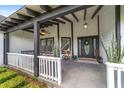Inviting front porch featuring a swing, ceiling fan and decorative accents at 10600 Se 32Nd Ave, Ocala, FL 34480