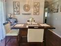 Inviting dining room featuring modern decor, a wooden table, and stylish chairs at 10945 Sw 75Th Ave, Ocala, FL 34476