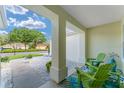 Inviting front porch with seating area, stone ground cover, and tasteful decor for relaxation at 12489 Se 90Th Ter, Summerfield, FL 34491