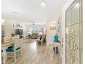 Open-concept living room showcasing lots of natural light, beautiful floors and stylish furnishings at 12489 Se 90Th Ter, Summerfield, FL 34491