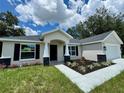 Charming single-story home with a welcoming front porch and well-maintained landscaping at 13305 Sw 114Th Pl, Dunnellon, FL 34432