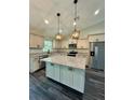 Modern kitchen featuring stainless steel appliances, granite countertops, and a large island at 13305 Sw 114Th Pl, Dunnellon, FL 34432