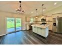 Bright, airy kitchen with stainless appliances, granite counters, and a sliding glass door to the yard at 13305 Sw 114Th Pl, Dunnellon, FL 34432