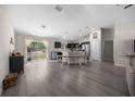 A spacious open-concept living room with a seamlessly blended modern kitchen with new stainless steel appliances at 13479 Sw 100Th Ln, Dunnellon, FL 34432