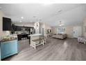 Bright living space connects kitchen and living room with modern furniture, stainless appliances and stylish island seating at 13479 Sw 100Th Ln, Dunnellon, FL 34432