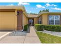 Inviting front entrance with manicured hedges, stone accents and a covered doorway at 13835 Se 85Th Cir, Summerfield, FL 34491