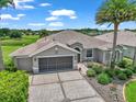 Beautiful single Gathering home featuring mature landscaping, a well-maintained lawn, and paved driveway at 1443 Sw 161St St, Ocala, FL 34473
