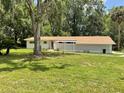 Inviting one-story home with a decorative cinder block privacy wall and a lush green lawn at 1523 Se 80Th St, Ocala, FL 34480