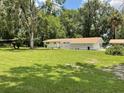 One-story home with a decorative cinder block privacy wall and a spacious green front yard at 1523 Se 80Th St, Ocala, FL 34480