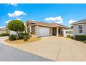 Charming home featuring an attached two car garage and a well maintained front yard with decorative landscaping at 1751 Brandenburg Ct, The Villages, FL 32163
