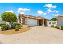 Charming home featuring an attached two car garage and a well maintained front yard with decorative landscaping at 1751 Brandenburg Ct, The Villages, FL 32163