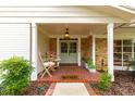 Charming front porch with brick flooring, seating, and a decorative entrance door at 1922 Se 13Th St, Ocala, FL 34471