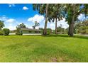 Expansive green yard with scattered mature shade trees surrounding the home at 1922 Se 13Th St, Ocala, FL 34471