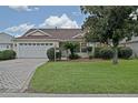 Charming home featuring a well-maintained front yard and spacious two-car garage at 3146 Williams Rd, The Villages, FL 32162