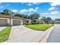 Charming townhome with a well-kept lawn, attached garage, and convenient driveway at 3707 Ne 17Th St, Ocala, FL 34470