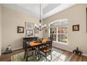 Dining room with wood floors, classic chandelier, and large arched window at 3948 Se 4Th Ter, Ocala, FL 34480