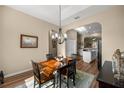 Dining room with wood floors, classic chandelier, and open archway at 3948 Se 4Th Ter, Ocala, FL 34480