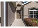 Close up of front door with sidelight window and manicured landscaping at 3948 Se 4Th Ter, Ocala, FL 34480