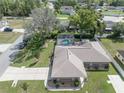 A view of the home featuring a screened-in pool, spacious yard, and neighborhood at 5347 Pecan Rd, Ocala, FL 34472