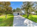 Charming single-story home with well-maintained lawn and inviting curb appeal on a sunny day at 6113 Sw 101St Pl, Ocala, FL 34476