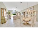 Open-concept living room with large windows providing natural light, tile floors, and neutral furnishings at 6330 Sw 117Th Loop, Ocala, FL 34476