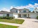 Charming home with a spacious driveway, manicured lawn, and a welcoming front porch with stone accents at 7067 Sw 60Th Ln, Ocala, FL 34474