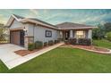 Beautifully landscaped front yard with lush green grass, decorative bushes, and a stone-accented walkway at 7454 Sw 101St Ave, Ocala, FL 34481