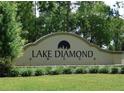 Community sign for Lake Diamond, enhanced by vibrant green landscaping at 80 Hickory Course Loop, Ocala, FL 34472