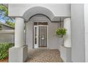 Welcoming front entrance with decorative door and hanging plant at 8775 Sw 192 Ct, Dunnellon, FL 34432