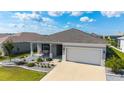 Charming single-story home featuring a well-manicured lawn and a two-car garage at 8913 Sw 76Th Ln, Ocala, FL 34481