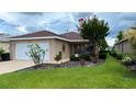 Charming single-story home featuring a well-manicured lawn and delightful landscaping at 9047 Sw 102Nd Cir, Ocala, FL 34481