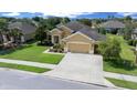 Well-maintained single-story home with a long driveway, a two-car garage, and verdant landscaping on a sunny day at 9948 Sw 69Th Ln, Ocala, FL 34481