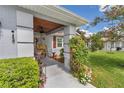 Inviting covered front porch with beautiful columns and lush landscaping at 10086 Sw 62Nd Terrace Rd, Ocala, FL 34476