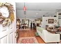 Open-concept living space with hardwood floors and seamless flow to the dining area at 10086 Sw 62Nd Terrace Rd, Ocala, FL 34476