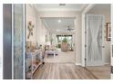 Inviting entryway showcases beautiful wood-look tile flooring leading into the home's bright and open living space at 10597 Sw 90Th Street Rd, Ocala, FL 34481
