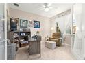 Cozy home office with neutral walls, comfortable seating, and ample natural light through sheer curtains at 10597 Sw 90Th Street Rd, Ocala, FL 34481
