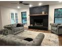Bright living area featuring a striking brick fireplace, neutral color palette, and ample natural light at 1245 Nw 73Rd Ter, Ocala, FL 34482