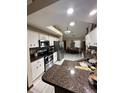 Bright kitchen features granite countertops, stainless steel appliances, and white cabinetry at 13506 Sw 43Rd Cir, Ocala, FL 34473