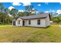 Front yard of a charming single-story home featuring a well-manicured lawn at 14876 Se 34Th Ter, Summerfield, FL 34491