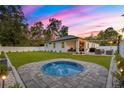 Spacious backyard featuring a covered patio, an outdoor seating area, and an in-ground spa at 155 Marion Oaks Pass, Ocala, FL 34473
