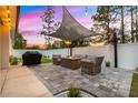 Covered patio with outdoor seating, a barbecue grill, fire pit, and decorative string lights at 155 Marion Oaks Pass, Ocala, FL 34473