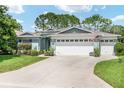 Charming single-story home with a well-manicured lawn and a three-car garage at 16023 Sw 14Th Avenue Rd, Ocala, FL 34473