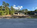 New construction home featuring concrete block walls and a concrete roof, set against a blue sky with white clouds at 19990 Sw 75Th St, Dunnellon, FL 34431