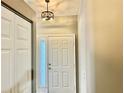 Bright entryway featuring a closet and decorative light fixture above the door at 2100 Nw 50Th Cir, Ocala, FL 34482