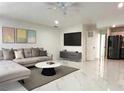 Open living room showcasing marble floors, a gray sectional couch, and modern decor at 21111 Sw Honeysuckle St, Dunnellon, FL 34431