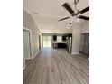 Open-concept living area featuring hardwood floors and sliding glass doors to the backyard at 2350 Sw 150Th Ct, Ocala, FL 34481