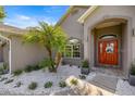 Inviting home entrance with decorative red door, landscaped white rock, and a modern accent at 2418 Se 22Nd Pl, Ocala, FL 34471